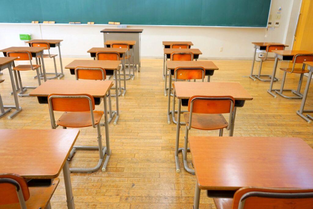 classtoom showing traditional desks attached to chairs 